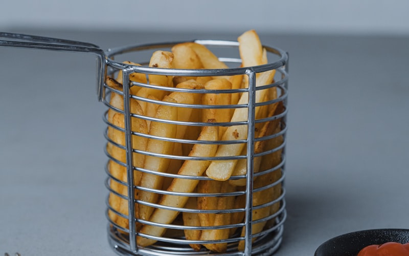 Six air fryers lined up on a kitchen counter from compact to full oven size