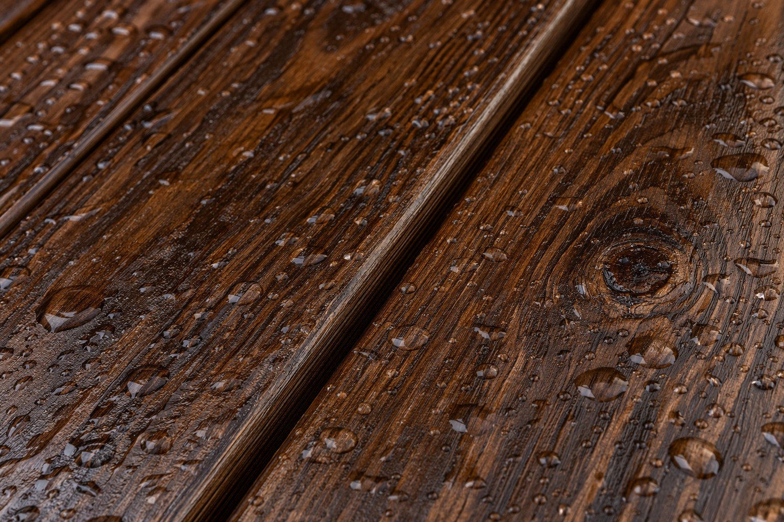 Pressure-treated 2x4 boards stained a rich dark walnut color, showing deep grain after sealing