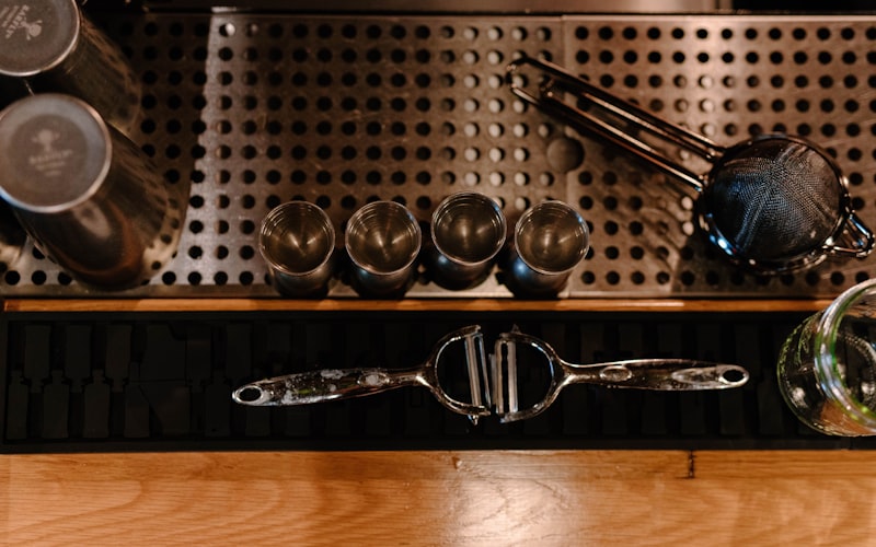 Cleaning supplies arranged on counter next to a stainless steel dishwasher