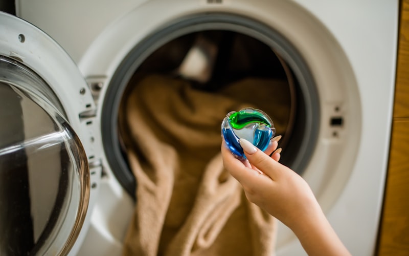 Washing machine with cleaning supplies arranged nearby, ready for a deep cleaning session
