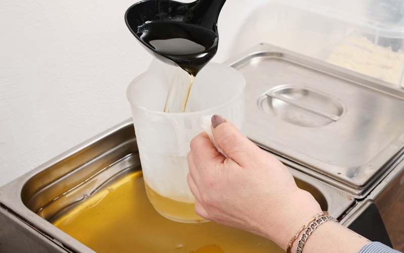 Close-up of hands using a microfiber cloth on a window pane with sunlight coming through