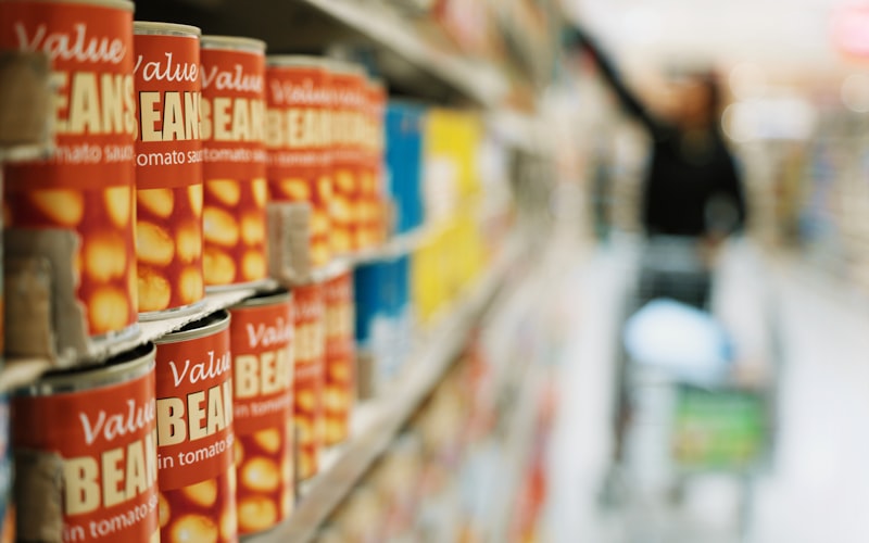 A smartphone displaying a grocery cashback app with savings highlighted, sitting next to a shopping receipt