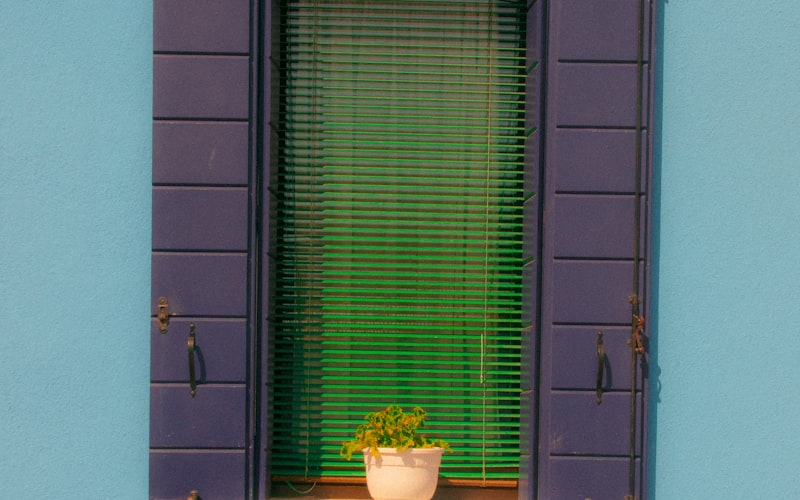 screen patch with unraveled edges being positioned over medium hole