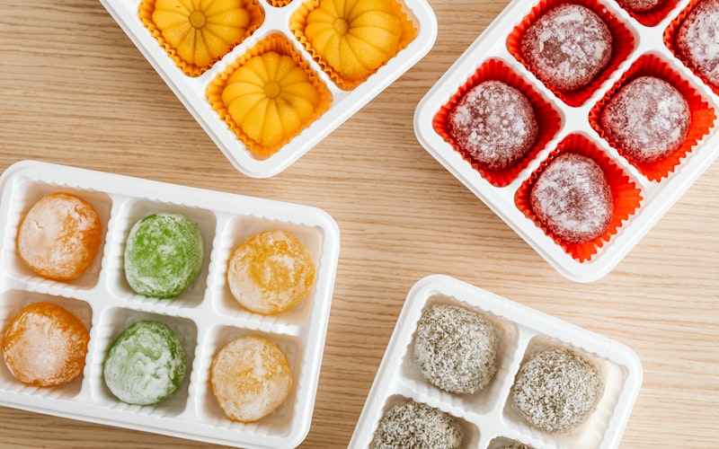 A well-organized freezer with clearly labeled zones showing proteins, vegetables, prepared meals, and breads in separate sections
