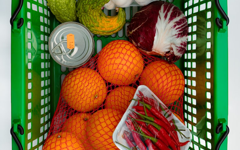 A chest freezer organized with labeled stackable bins showing different food categories in each bin