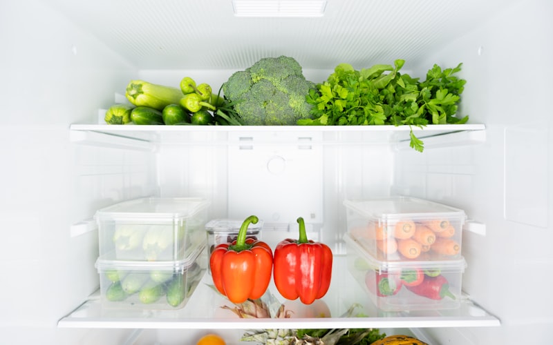 Well-organized refrigerator with clearly labeled zones showing proper food placement