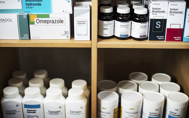 Neat and organized medicine cabinet with clear containers in a bathroom
