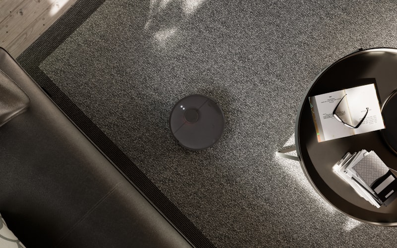 A neatly organized under-sink cabinet showing tiered shelving, labeled bins, and a tension rod holding spray bottles