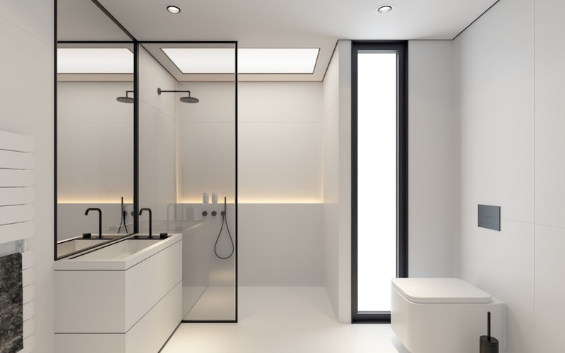 close-up of a hand using an angled brush to cut in paint along ceiling trim