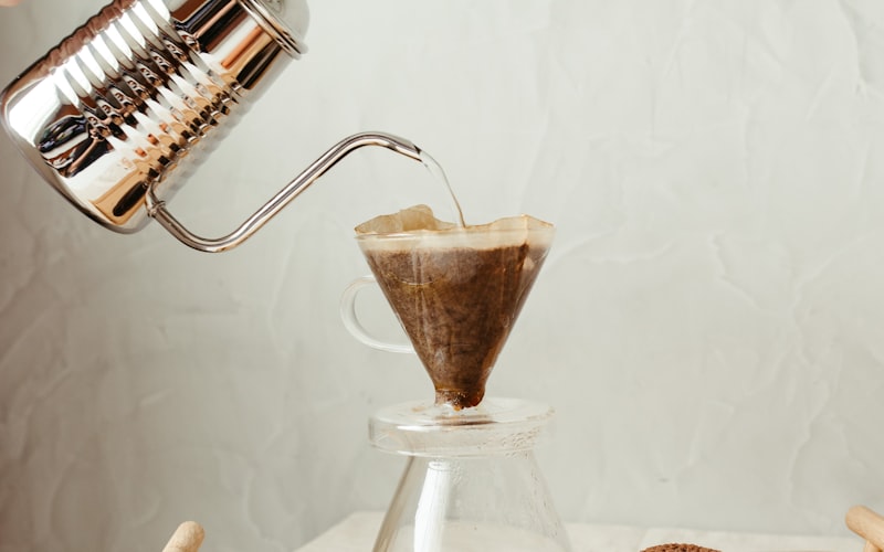 Flat illustration showing three coffee brewing methods side by side: French press, pour-over, and drip maker with cost-per-cup labels
