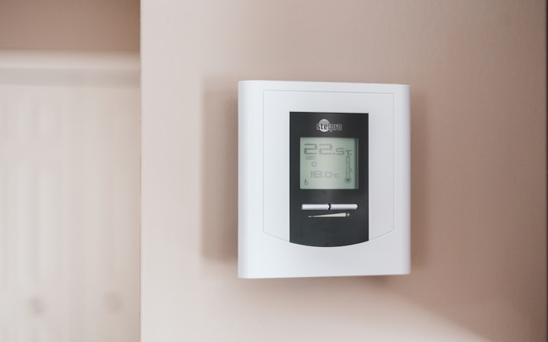 A thermostat set to an energy-efficient temperature in a bright home