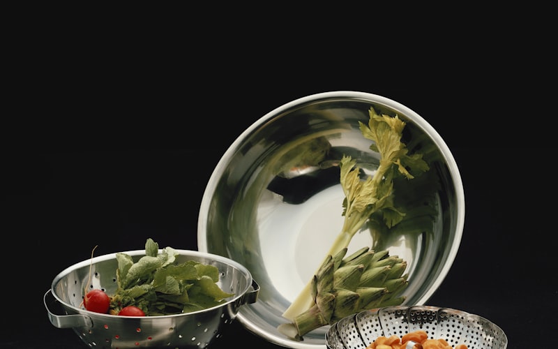 Fresh herbs stored in various methods — jars of water, damp towels, and containers in a bright kitchen