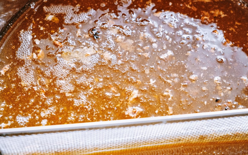 Person looking frustrated at a slow-draining sink with standing water